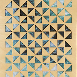 blue geometric patterns, laser cut onto wooden board.