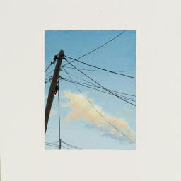 utility poll, power lines attached, cloudy blue sky.