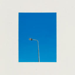 single street light in deep blue sky.