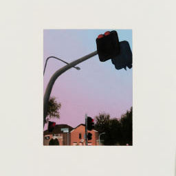 traffic light hanging over pastel pink and purple sky and houses.