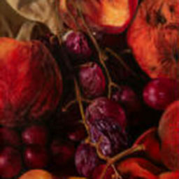 close-up of red apples and grapes, warm hues.