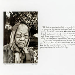 portrait old woman, round glasses, scarf wrapped around her head, cursive writing on the right, black and white photograph.