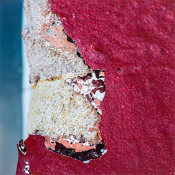 close-up of natural surface covered in eroding pink material.