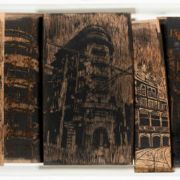 long panel of woodblocks with printed historical building features.