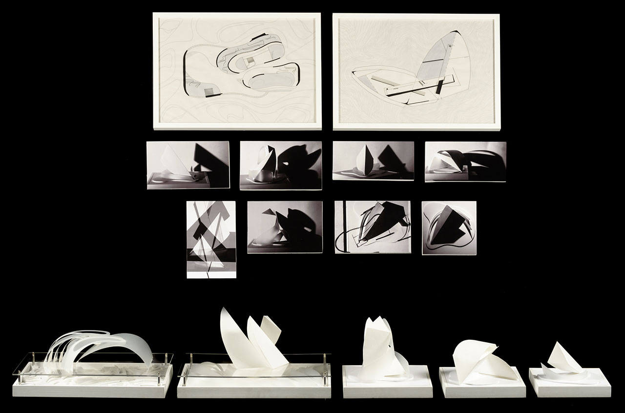 five white arched individual models in a line, eight photographs of the models in black and white above the physical structures and two larger detailed line drawings of the models at the top on a black background.