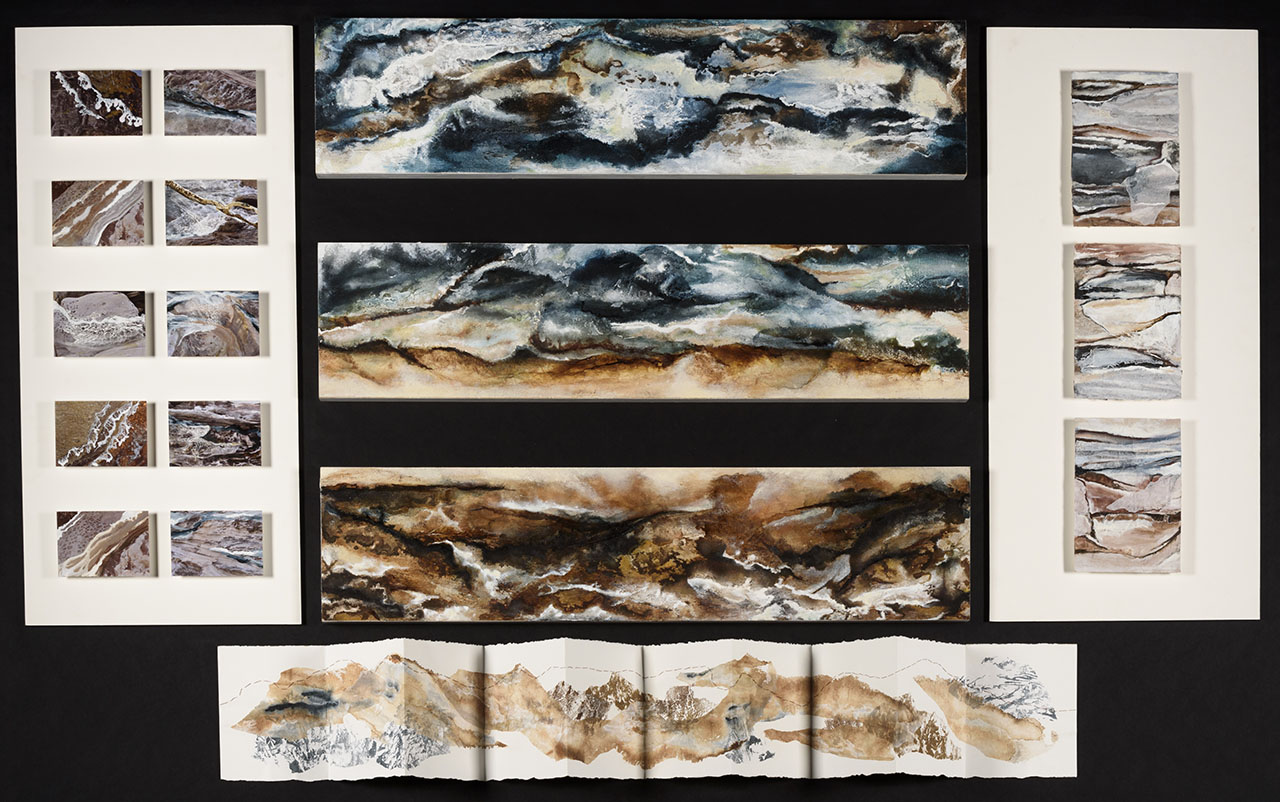 watercolour paintings of rough landscapes in earthy tones and blues, four long panels and thirteen smaller panels, close-ups of rocks and water.