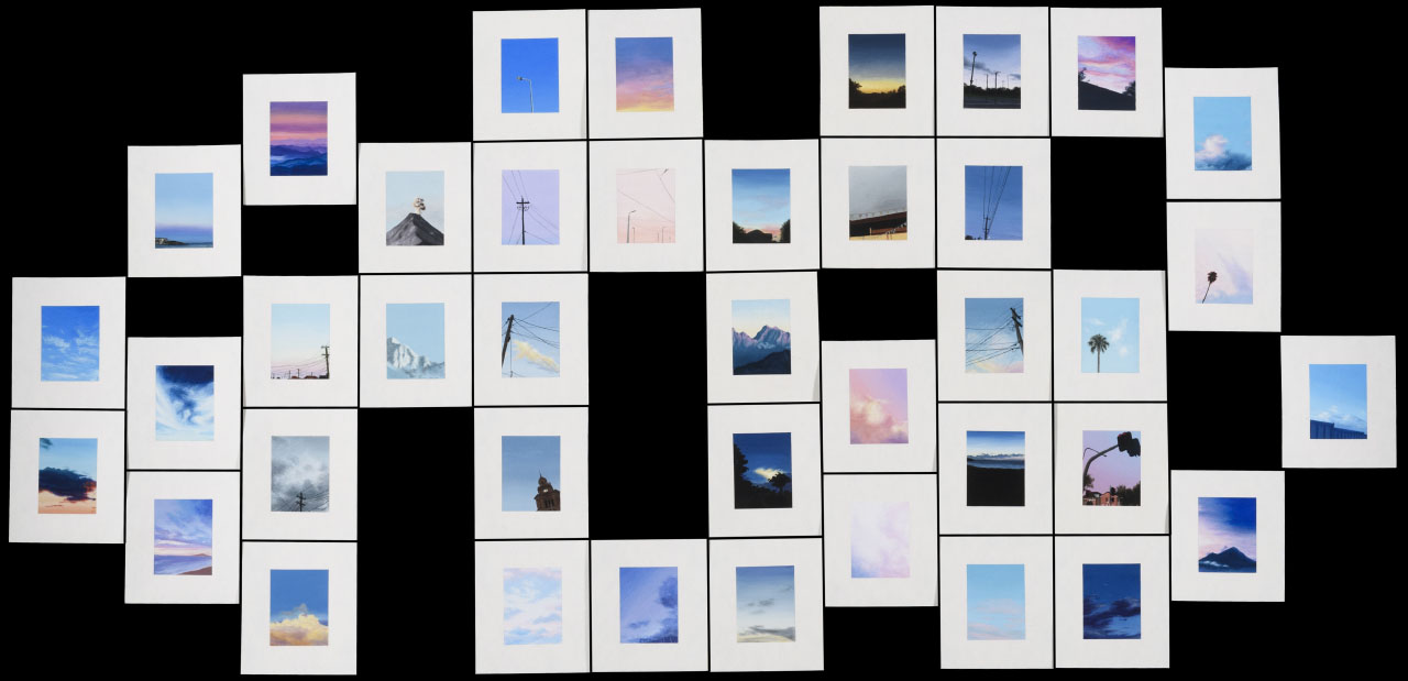 forty polaroid sized paintings placed together in a jigsaw formation, intricate snapshots of landscapes in squares in vivid pinks and blues.