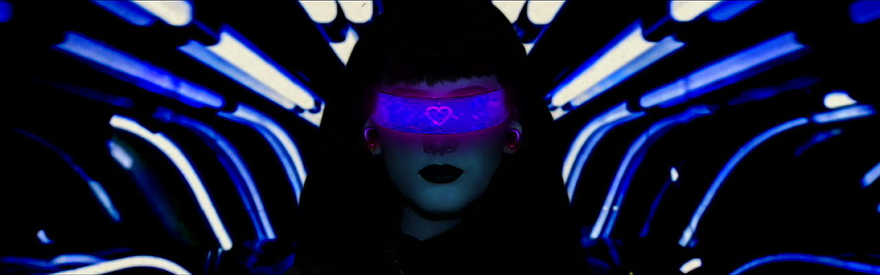 futuristic woman with cyclops glasses on staring straight ahead, blue light beams surrounding dark frame, the words 'make sure that your Virtual Reality Headset is comfortable' along the bottom in small print.