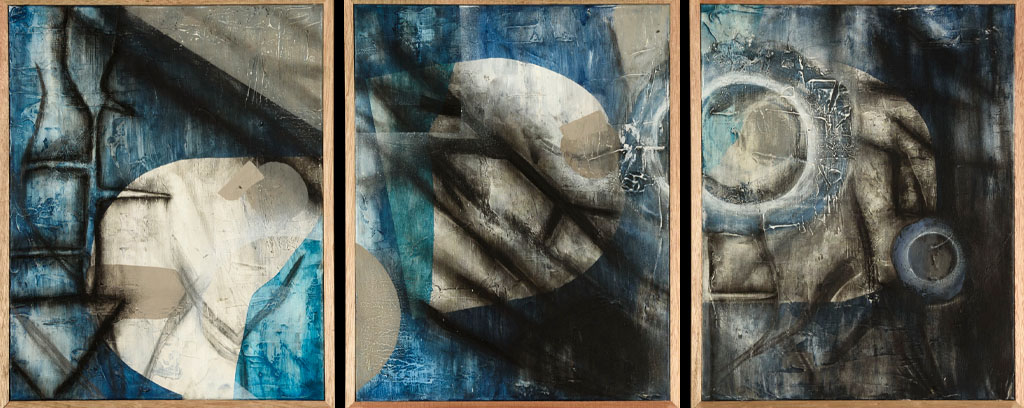 three abstract panels with circular features and shaded lines in tones of blue and off-white and a tall abstract statue made of sticks, rocks and fabric. 