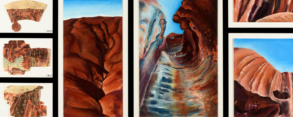 eight paintings of rock surfaces, cavernous spaces and aerial views in earth tones and sky blue, varied sizing.