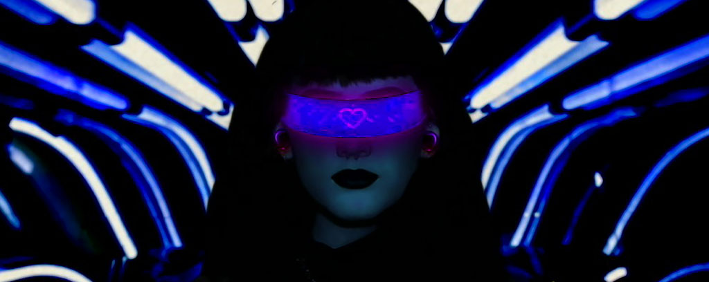 futuristic woman with cyclops glasses on staring straight ahead, blue light beams surrounding dark frame, the words 'make sure that your Virtual Reality Headset is comfortable' along the bottom in small print.