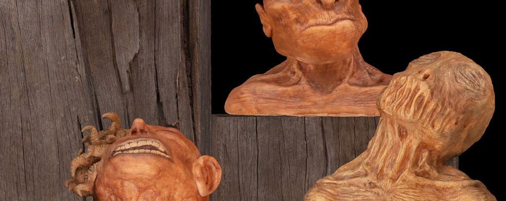 Collection of four sculptures of genetically modified human heads.