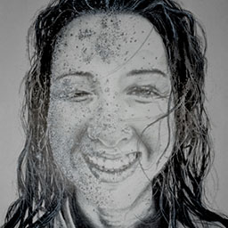 close up black and white pencil drawing of young woman smiling with dark hair