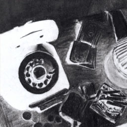 Black and white image of rotery phone on desk