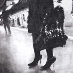 Black and white image of womans legs wearing high heels and holding a handbag standing on a train platform