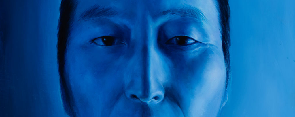 Three large-scale blue toned portraits of a male and two females