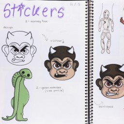 Close up of visual arts diary displaying sketches of monsters for a body of work