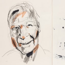 Close up of visual arts diary displaying a sketches of an old man smiling