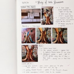 Close up of visual arts diary displaying progress images of a tree for a body of work