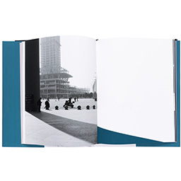 Photo book, p[ened to a black and white photo of a city.